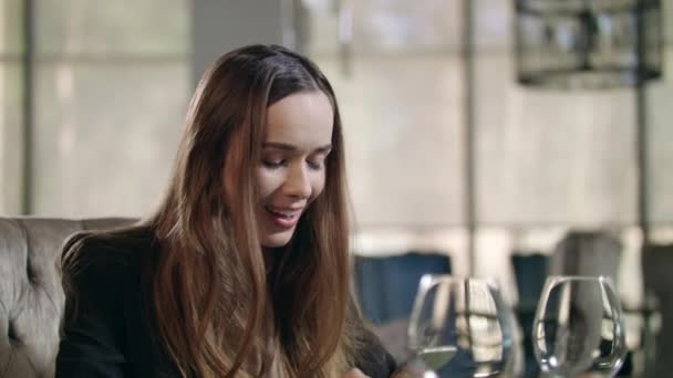 Excited woman using smartphone in restaurant. Business woman enjoy good news — Stock Video