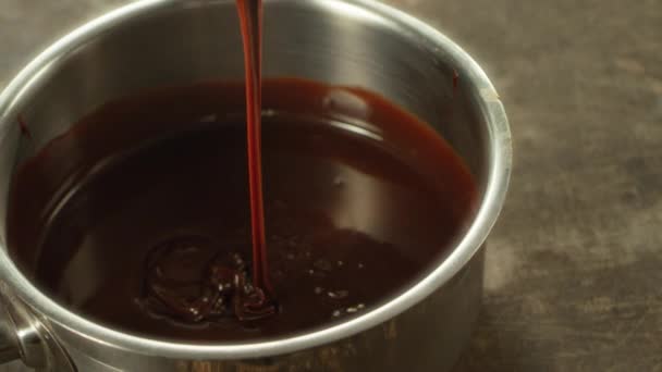 Closeup melted chocolate mixing in slow motion. Macro of liquid chocolate — Stock Video