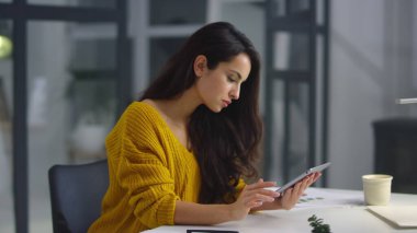 Businesswoman analyzing information on pad. Woman touching green screen on pad