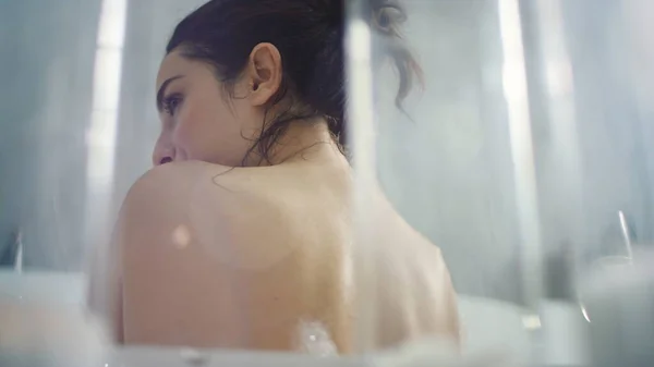 Hot woman washing body in bath in slow motion. Sensual woman touching shoulder