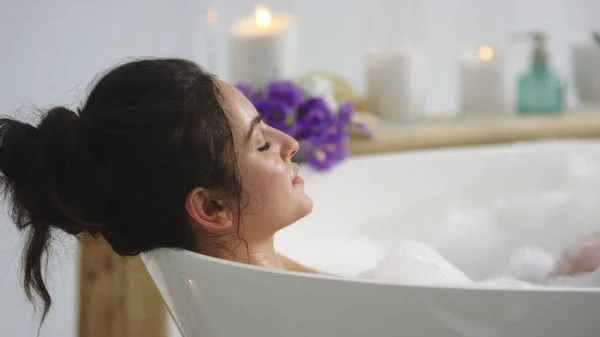 Closeup relaxed woman blowing foam in bathroom. Sexy girl washing hands in bath — Stock Photo, Image