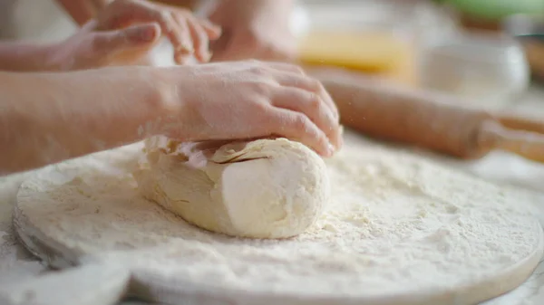 Woman and girl kneading dough on kitchen in slow motion — Stockfoto