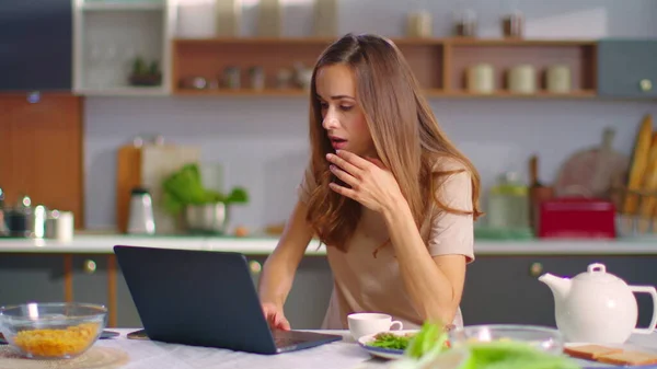 Businesswoman closing laptop after work at kitchen. Lady going out from home