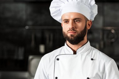 Mutfak restoranında profesyonel şef. Üniformalı erkek aşçının portresi..