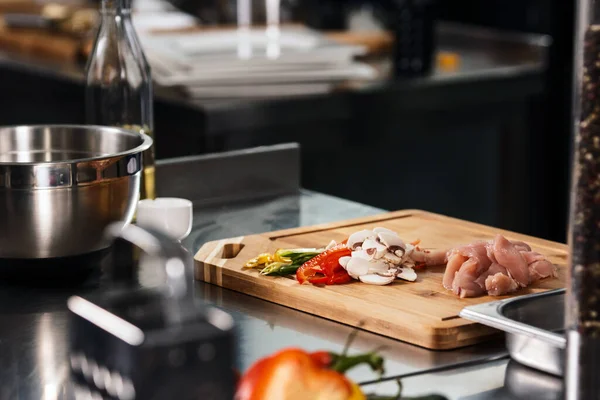 Sunn mat ved kjøkkenbordet. Friske skivegrønnsaker og kylling på kjøkkenet. – stockfoto