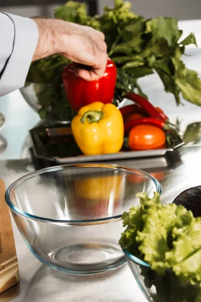 Healthy food at kitchen restaurant. Male cooker hands preparing organic food.