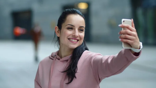 Close up smiling woman using phone for video call. Cheerful girl talking online