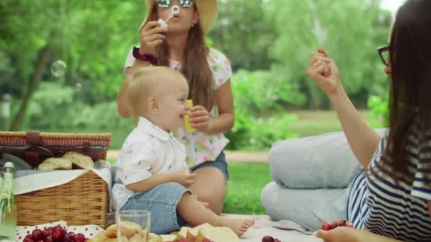 Familia petrece timp împreună în parc. Mama și fiul ținând cireșe în mâini — Videoclip de stoc