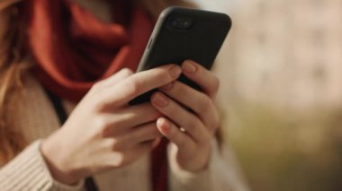 Kadın elleri dışarıda telefonla mesaj yazıyor. Akıllı telefon yazan bilinmeyen kız.