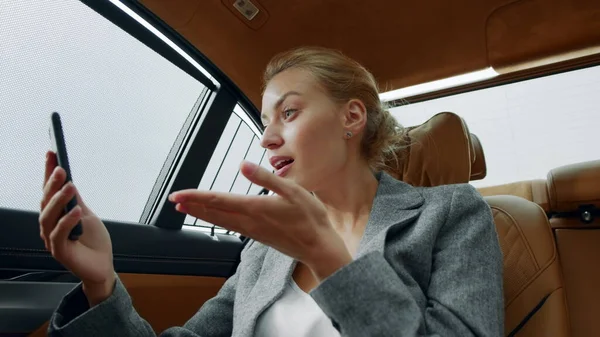 Closeup woman making video call at car. Exited woman celebrating victory at car — Stock Photo, Image