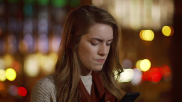 Chica enojada usando el teléfono celular al aire libre. Mujer irritable de pie con teléfono móvil . — Vídeos de Stock