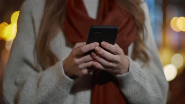 Woman hands touching phone screen outdoors. Unknown girl using cellphone outside — Stock Video