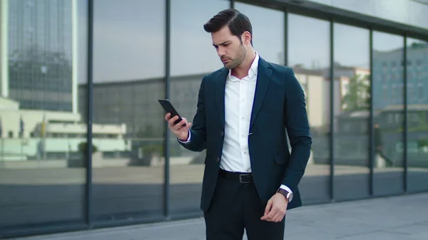 Closeup man taking phone out of pocket. Businessman celebrating victory outdoor — Stock Photo, Image