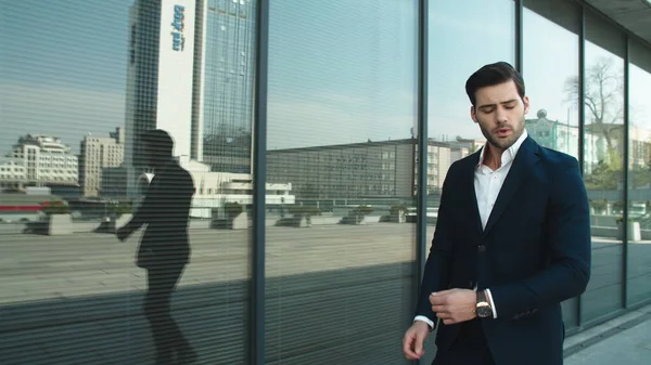 Closeup man checking time on watch. Business man going upstairs at street — Stockfoto