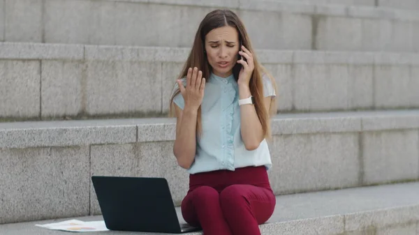 Businesswoman yelling in smartphone at street. Manager using cellphone in city