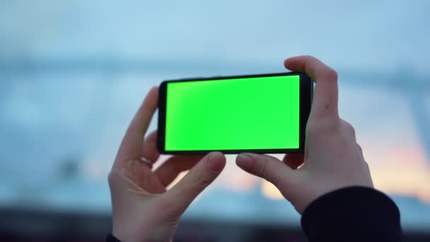 Manos de mujer usando smartphone con pantalla verde al aire libre. Señora sosteniendo el teléfono celular — Vídeo de stock