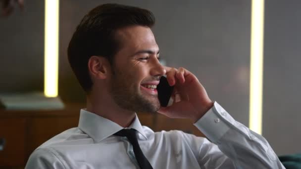 Portrait of happy businessman talking on mobile phone at remote workplace — Stock Video