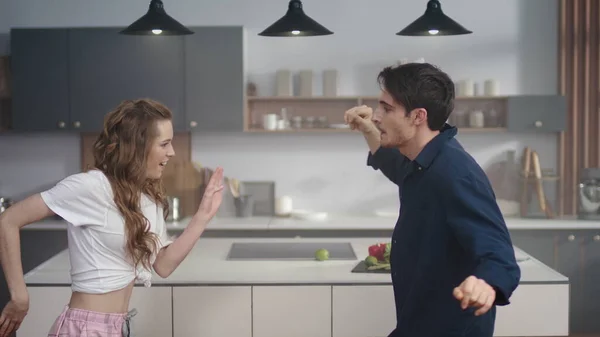 Ευτυχισμένο ζευγάρι που χορεύουν μαζί στο φόντο της κουζίνας. Ενθουσιασμένοι φίλοι κινούνται σώμα — Φωτογραφία Αρχείου