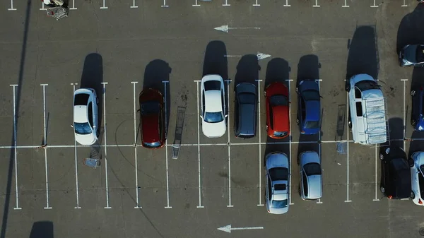 Copter filming modern cars parking near supermarket parking lots