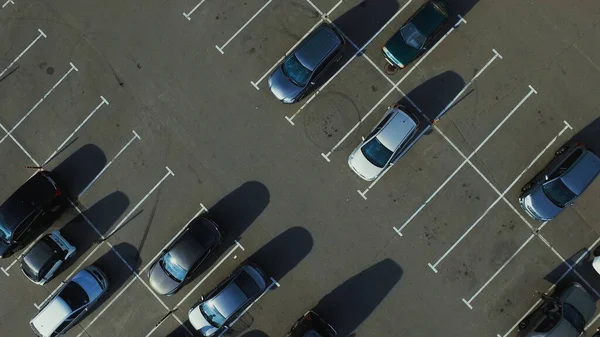 Drone footage people walking around parking place. Drone flying over parking