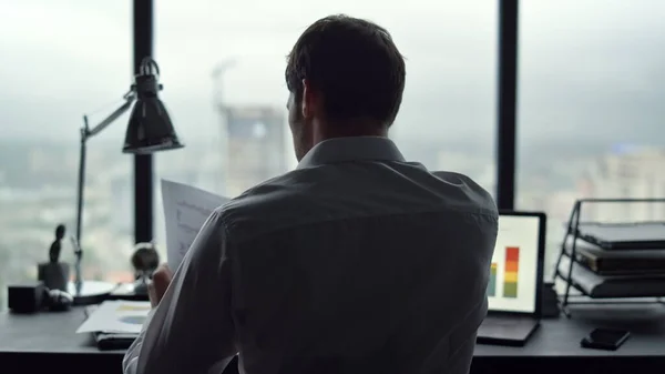 Un homme d'affaires qui regarde des documents au bureau. Homme stressé au travail — Photo