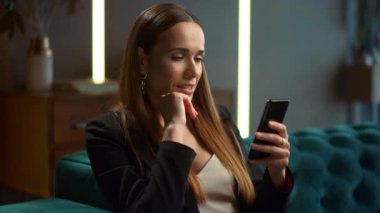 Modern iç mekanlarda akıllı telefon kullanan bir iş kadını. Telefondaki profesyonel mesajlaşma