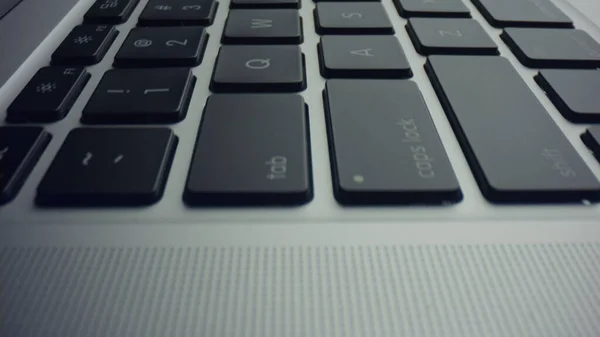 Keyboard on laptop computer. Dolly shot of grey laptop with black keys — Stock Photo, Image