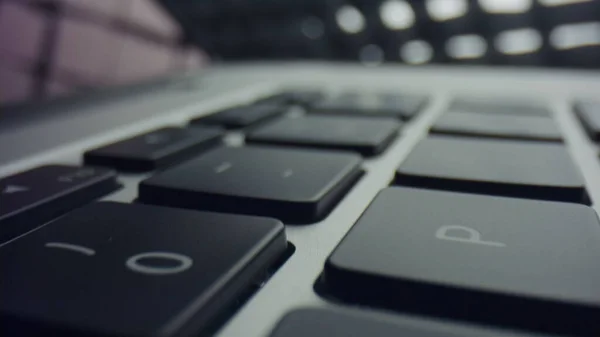 Black keyboard of grey laptop computer. Modern laptop computer with touchpad — Stock Photo, Image