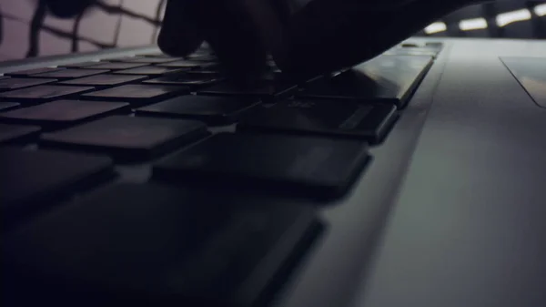 Man hands typing on laptop keyboard. Male person working on grey laptop computer — Stock Photo, Image