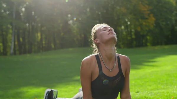 Engelli kadın parkta yoga yapıyor. Sabahları vücudu geren bir kız. — Stok fotoğraf