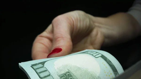 Γυναίκα που μετράει μετρητά σε μαύρο φόντο. Χρηματοοικονομική και ταμειακή έννοια — Φωτογραφία Αρχείου