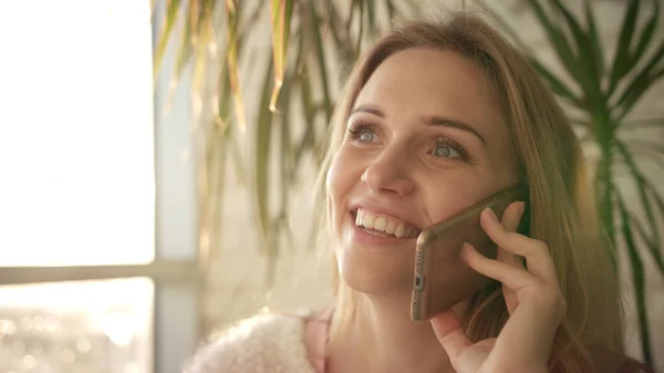 Beautiful woman talking mobile. Smiling girl speaking phone