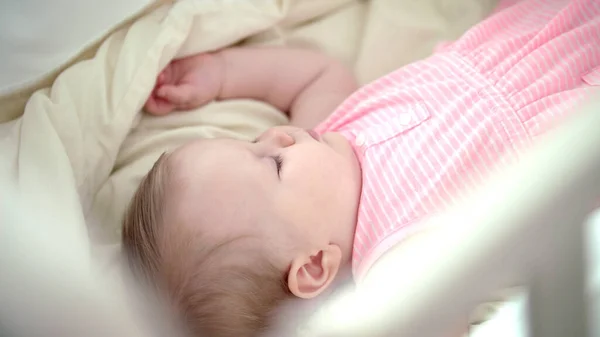 아름다운 아가씨가 침대에서 자고 있어. 자는 꿈을 꿨어. 요람에서 자고 있는 유아 소녀 — 스톡 사진