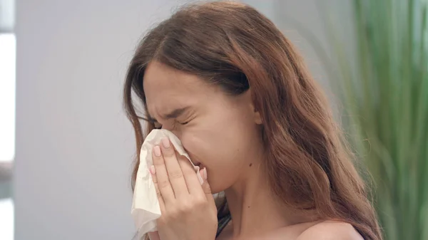 Unhealthy young girl with runny nose while cold disease sneezing in handkerchief — Stock Photo, Image