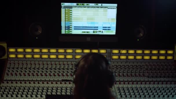 Unrecognizable sound engineer touching soundboard in recording music — Stock Video