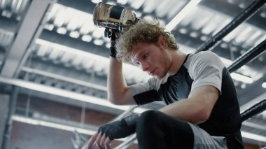 Spor salonunda susuzluğunu gideren sıcak bir dövüşçü. Kickboxer spor salonunda ferahlatıcı