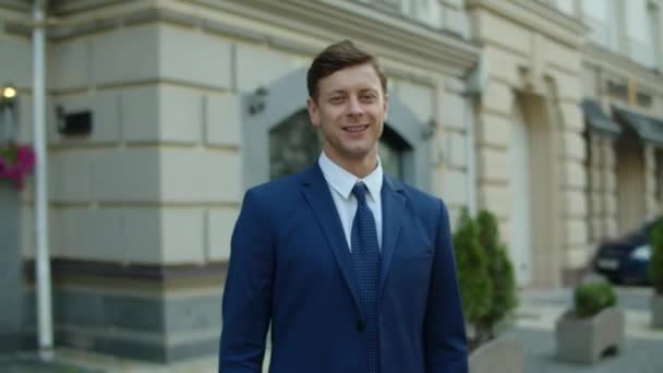 Portrait of successful businessman standing at city street. Man showing okay — Stock Video