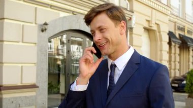 Sokakta telefonu olan profesyonel bir erkek portre. Dışarıda cep telefonundan konuşan adam.