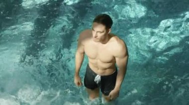 Yüzme havuzuna dalan atletik vücut adam. Girdabın önünde duran seksi hippi çocuk..