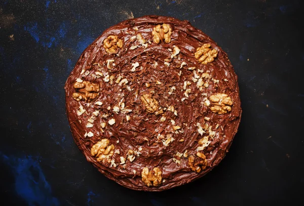 Chocolate cake with nuts, black background, top views