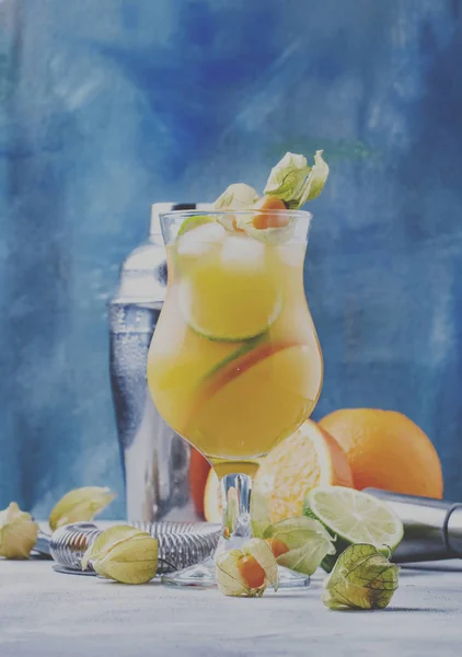Alcoholic cocktail summer breeze with syrup, lime, orange, beer and ice