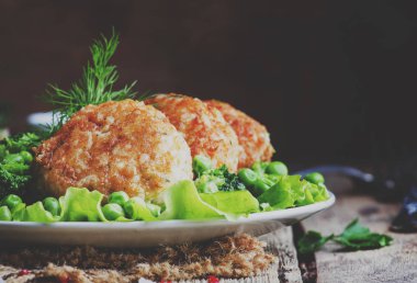 Balık pirzola veya cod ve pike köfte yeşil bezelye ve brokoli, rustik tarzı, seçici odak bir garnitür ile levrek