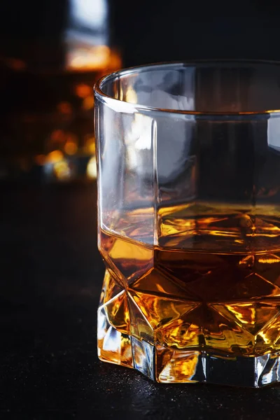 Bourbon in glasses, american corn whiskey, dark bar counter, selective focus