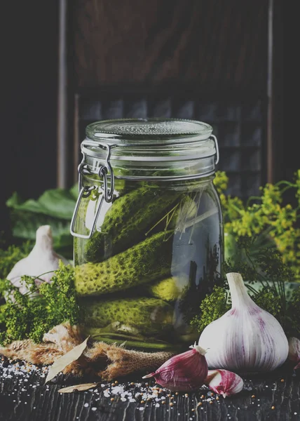 Homemade marinated or pickled cucumbers with dill, garlic and spices in big glass jar on rustic brown table, selective focus — Stock Image Homemade Marinated Pickled Cucumbers Dill Garlic Spices Big Glass Jar Stock Photo