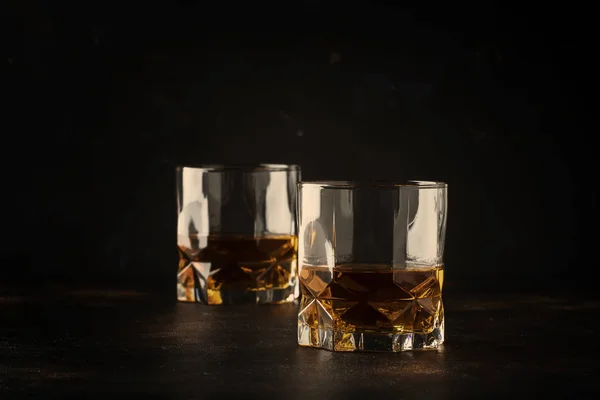 Bourbon in glasses, american corn whiskey, dark bar counter, selective focus