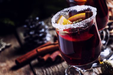 Yeşil çam dalları ve ışıklar, rustik ahşap masa, seçici odak arka plan üzerinde star Noel ve yeni yıl festival içki, tarçın, kakule, portakal ve anason ile sıcak mulled şarap