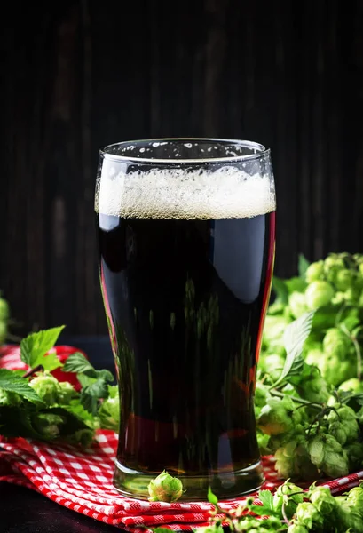 Dark beer, ale or stout iin big glass, dark bar counter, selective focus