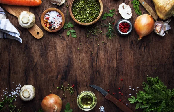 Ingredients for cooking green lentils with mushrooms and vegetables, spices and herbs, vintage wooden kitchen table background, place for text. Vegan or vegetarian food, clean food concept. Top view, flat lay — Stock Image Ingredients Cooking Green Lentils Mushrooms Vegetables Spices Herbs Vintage Wooden Royalty Free Stock Images