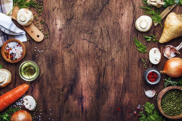 Ingredients for cooking green lentils with mushrooms and vegetables, spices and herbs, vintage wooden kitchen table background, place for text. Vegan or vegetarian food, clean food concept. Top view, flat lay — Stock Image Ingredients Cooking Green Lentils Mushrooms Vegetables Spices Herbs Vintage Wooden Royalty Free Stock Images