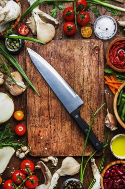 Yemek pişirme arka plan, hazırlık vejetaryen yemekleri, sebze, kökleri, baharatlar, mantar ve otlar için malzemeler. Büyük şefler bıçak. Sağlıklı gıda kavramı. Rustik ahşap masa arka plan, üstten görünüm